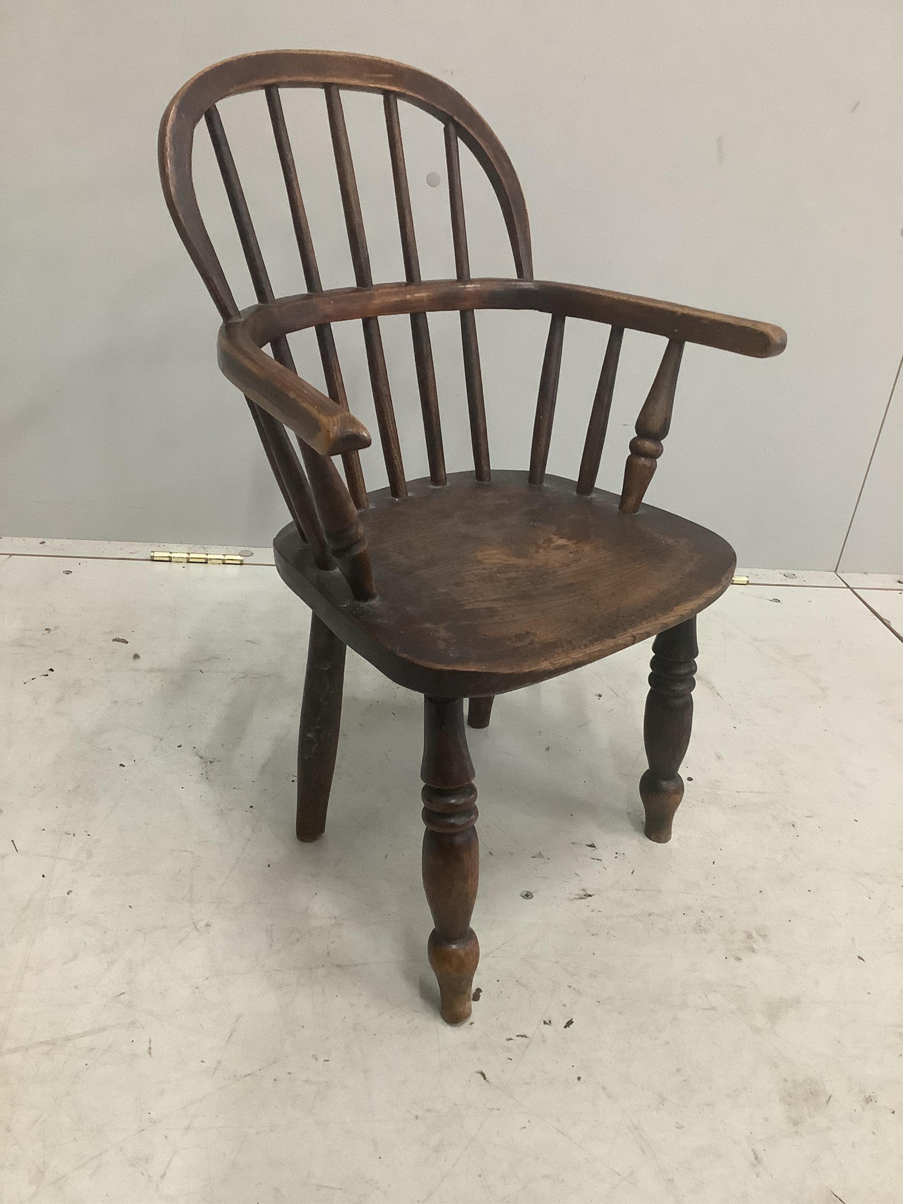 A Victorian ash and elm Windsor child's elbow chair, width 43cm, depth 28cm, height 60cm. Condition - fair